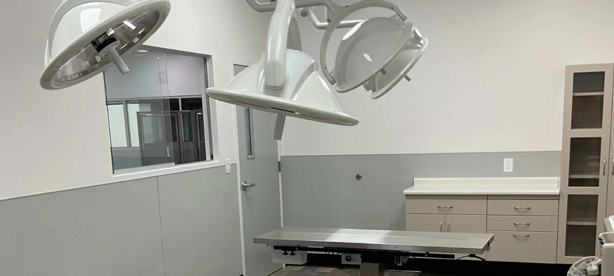 Exam room with lights, a table, and counter space